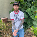 Chris Russell wearing showing his Tattoo from GUNGA MA standing in the garden at the space study, long beach. 