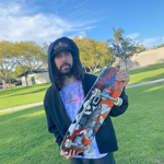 Al at silverado sk8 park holding his board, clear blue sky